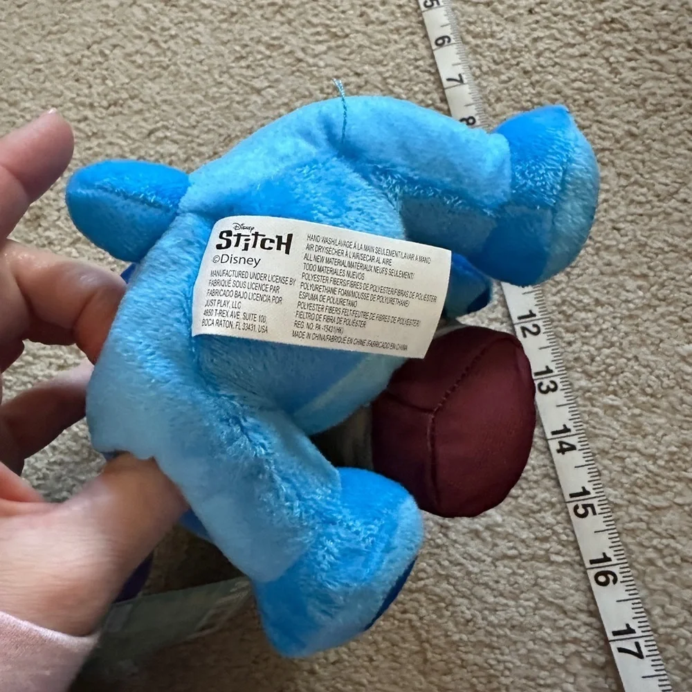 Stitch holding a coffee